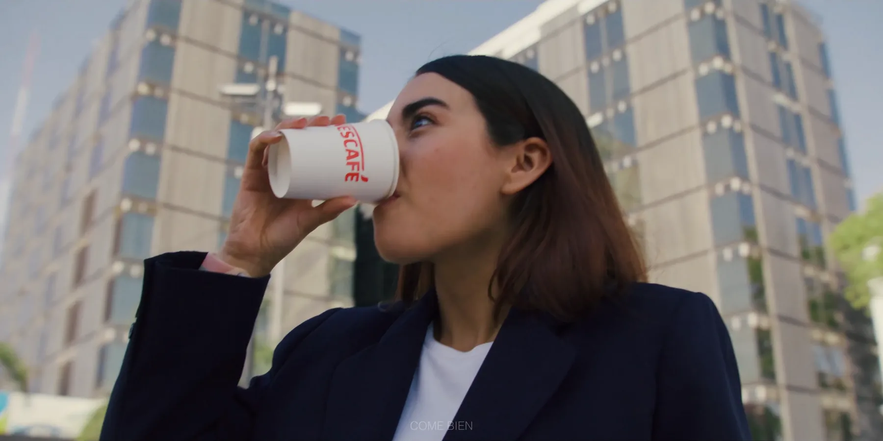 Mujer bebiendo café en la calle